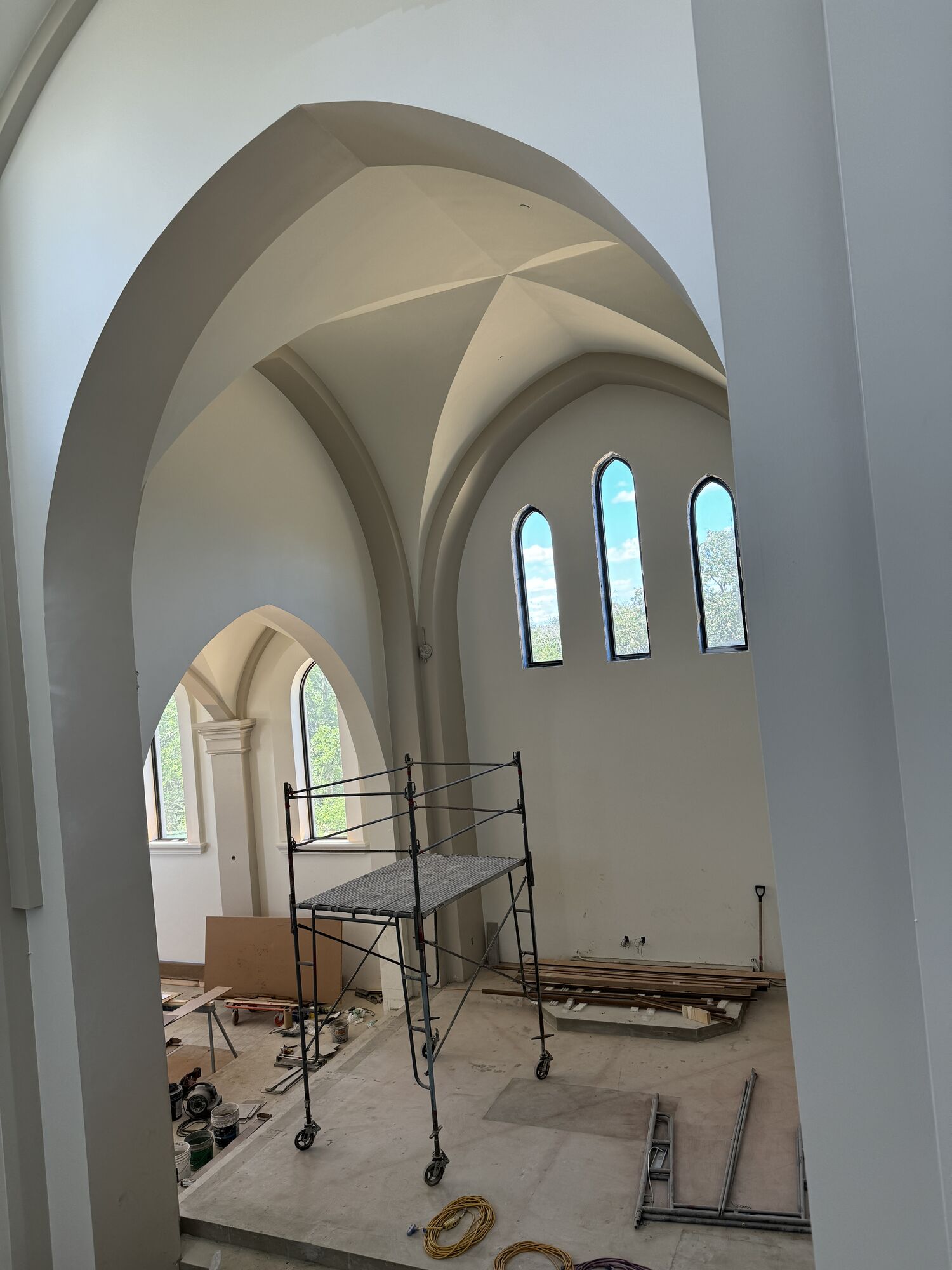 Pointed archway into a side chapel with lancet windows